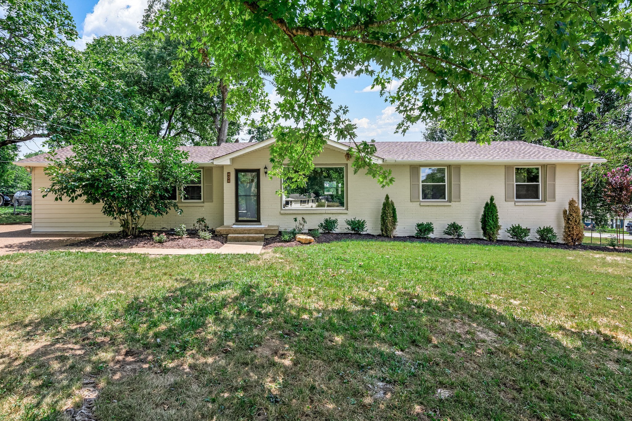 a front view of house with yard and green space