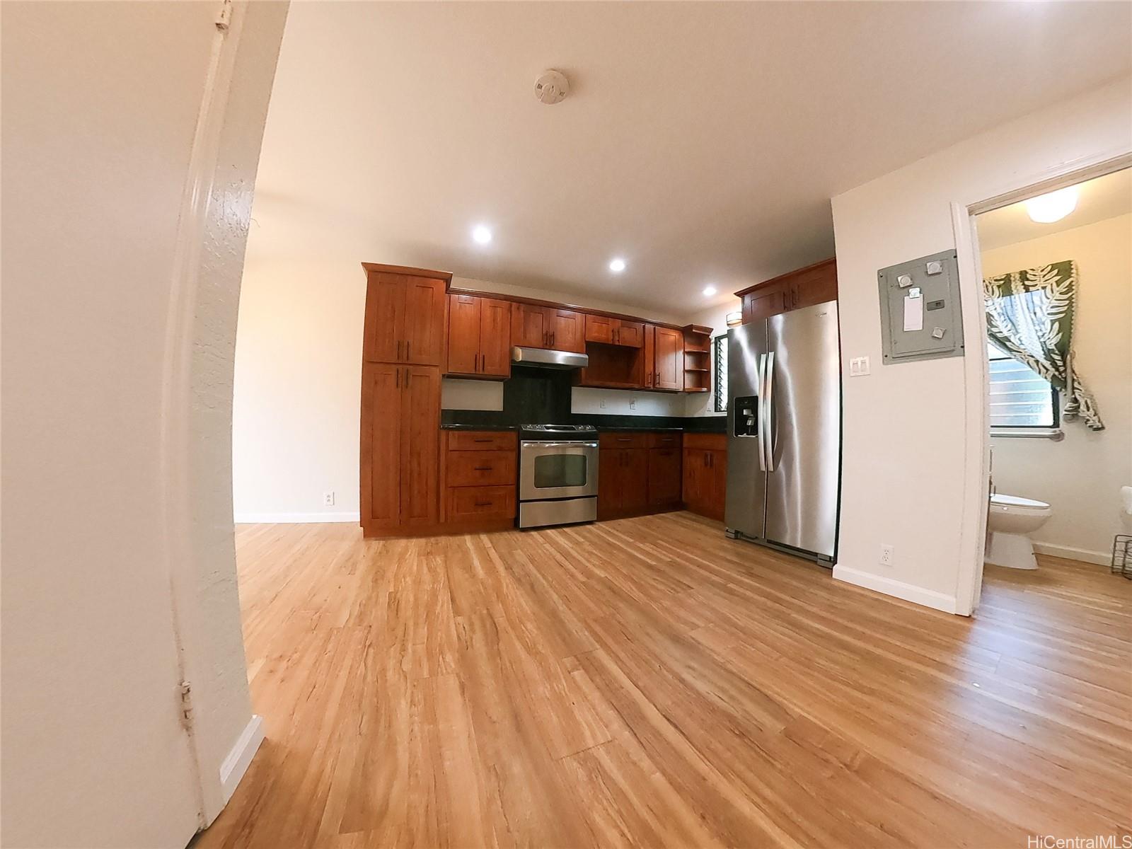 a view of kitchen with refrigerator microwave and wooden floor