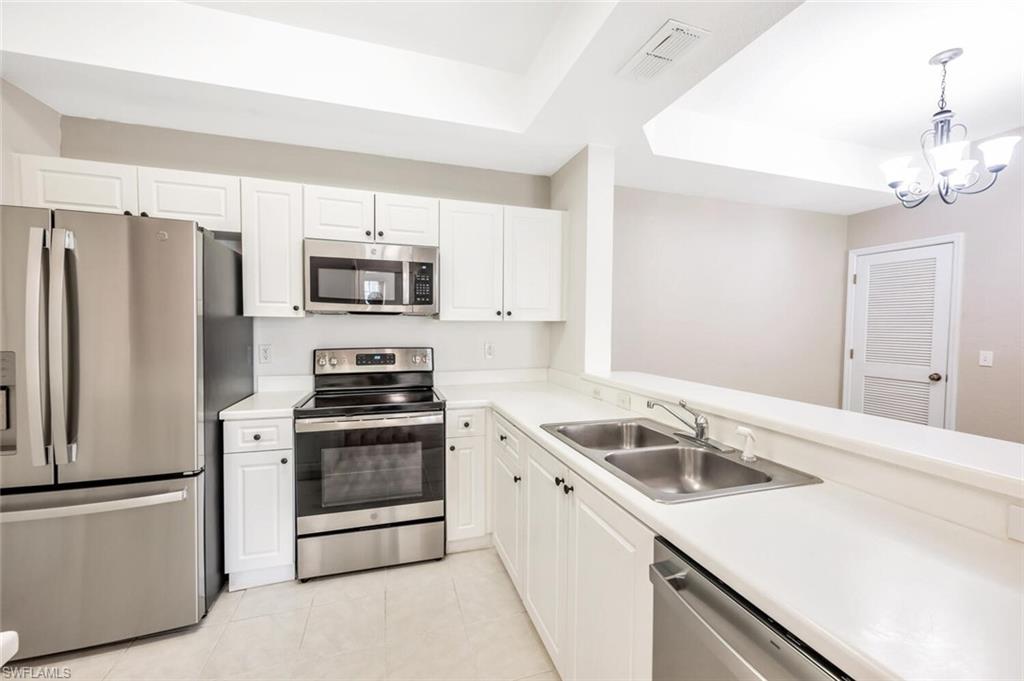 a kitchen with a sink stove and refrigerator