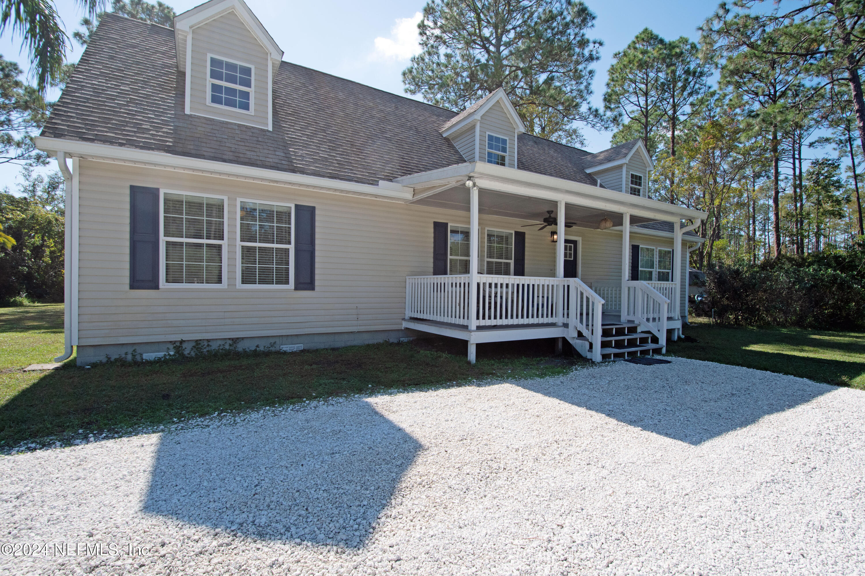 a view of a house with a yard and wooden fence