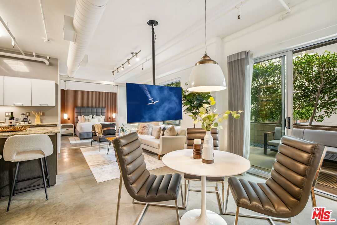 a view of a dining room with furniture window and outside view