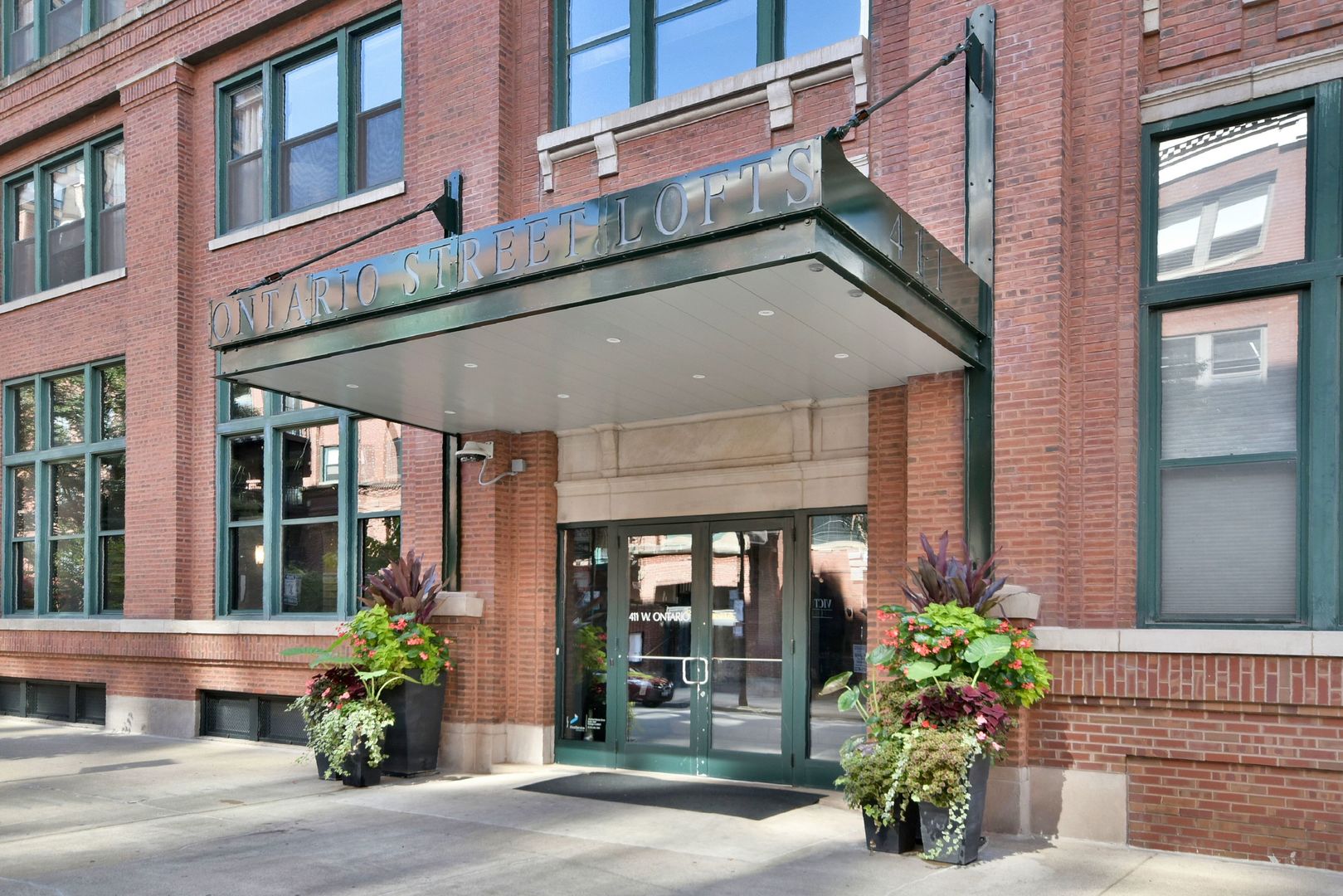 a view of a building with potted plants