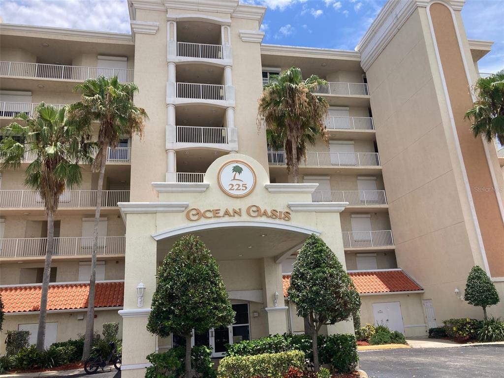 a front view of a multi story building with yard