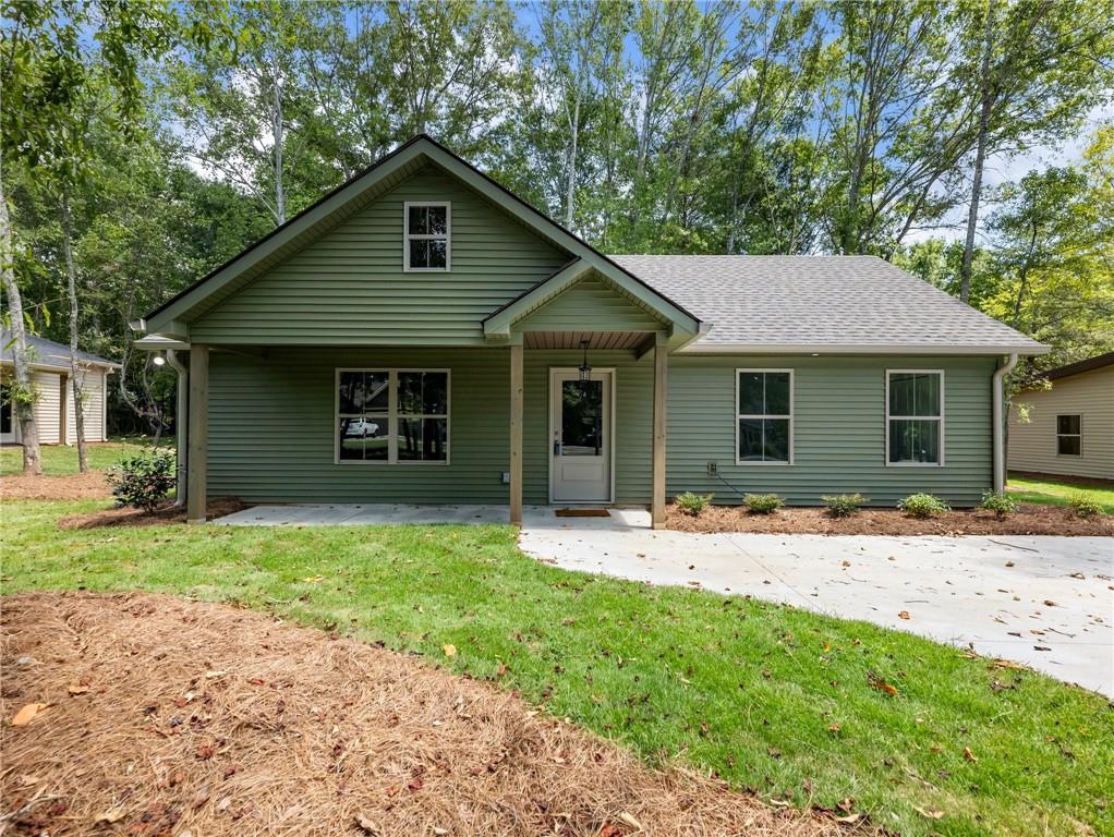 a front view of house with yard and green space