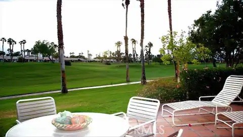 a view of a table and chairs in the garden