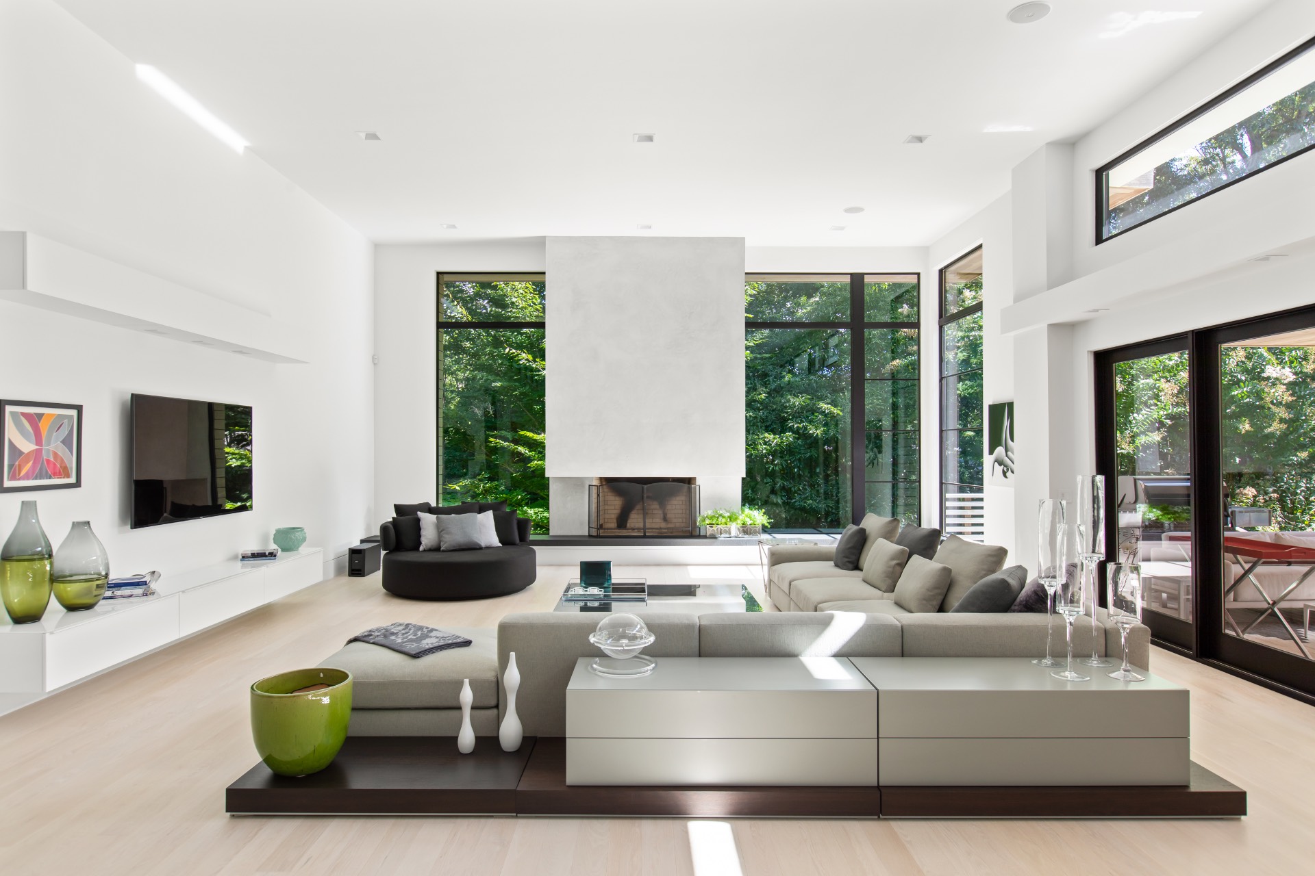 a living room with furniture large window and flat screen tv