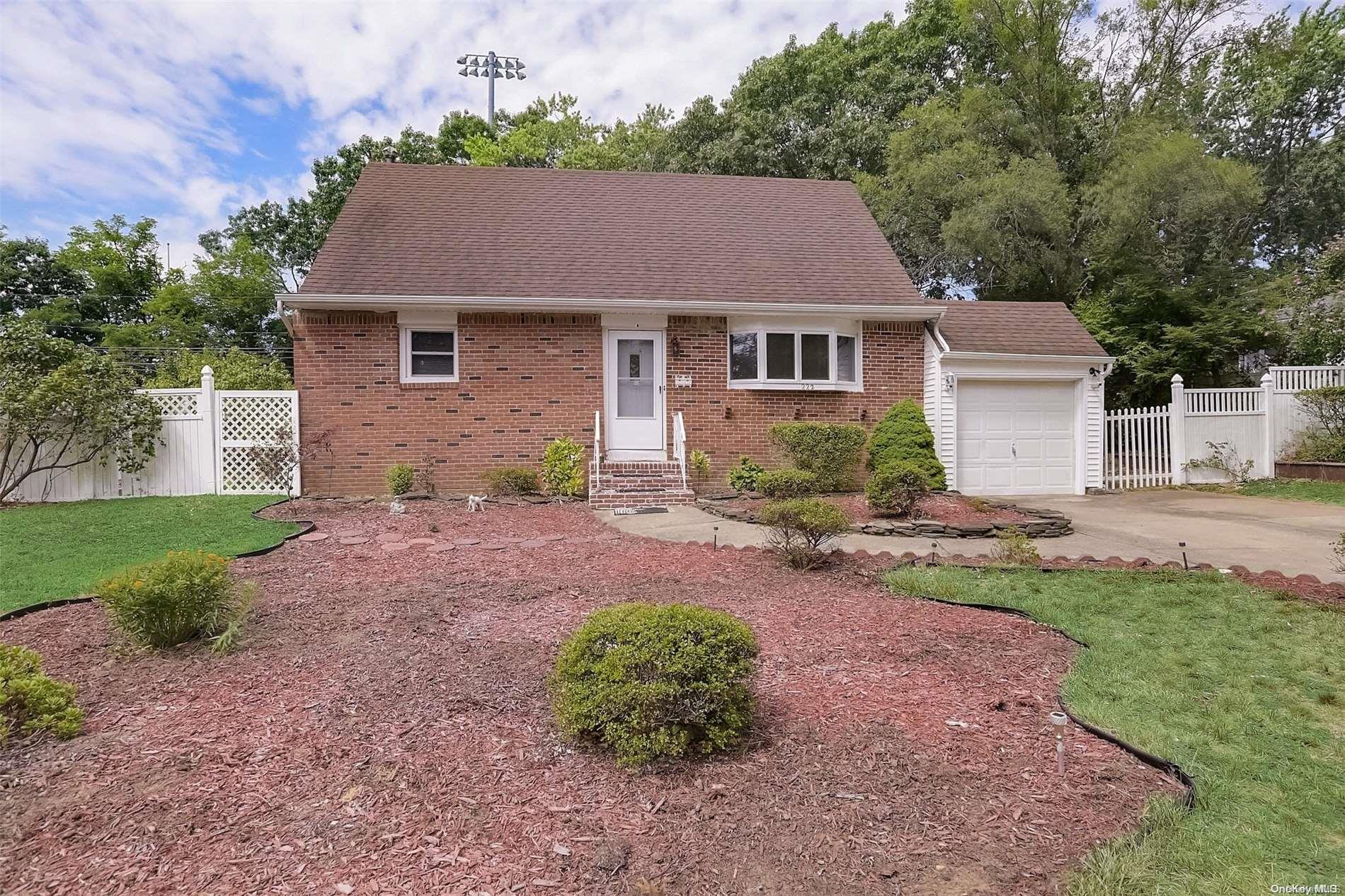 a aerial view of a house with a yard and a large tree