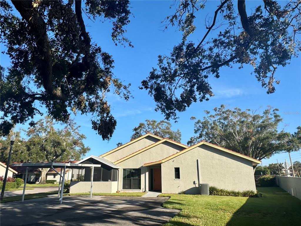 a view of house with a yard