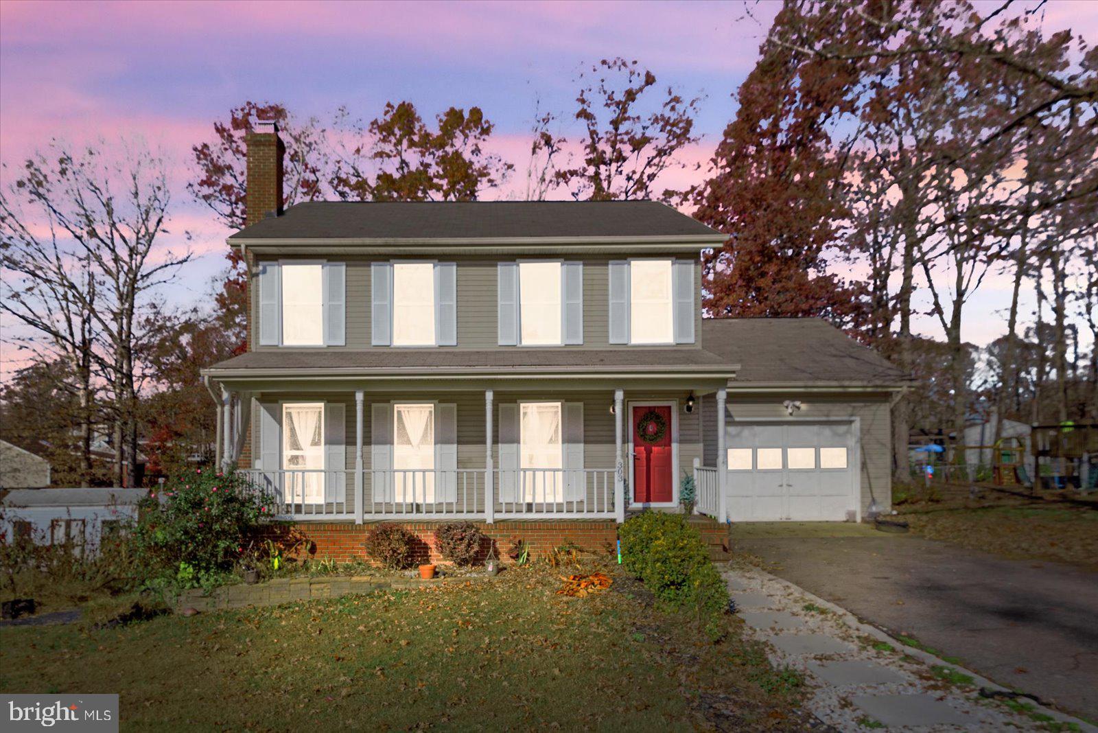 a front view of a house with a yard garage and outdoor seating