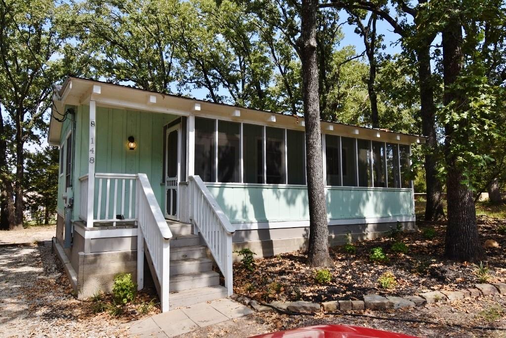 a view of a house with backyard and porch