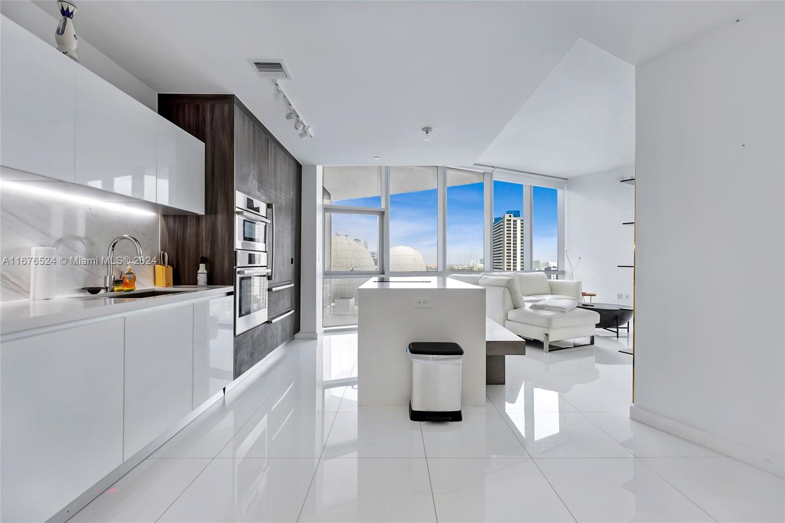 a kitchen with stainless steel appliances kitchen island granite countertop a sink and cabinets