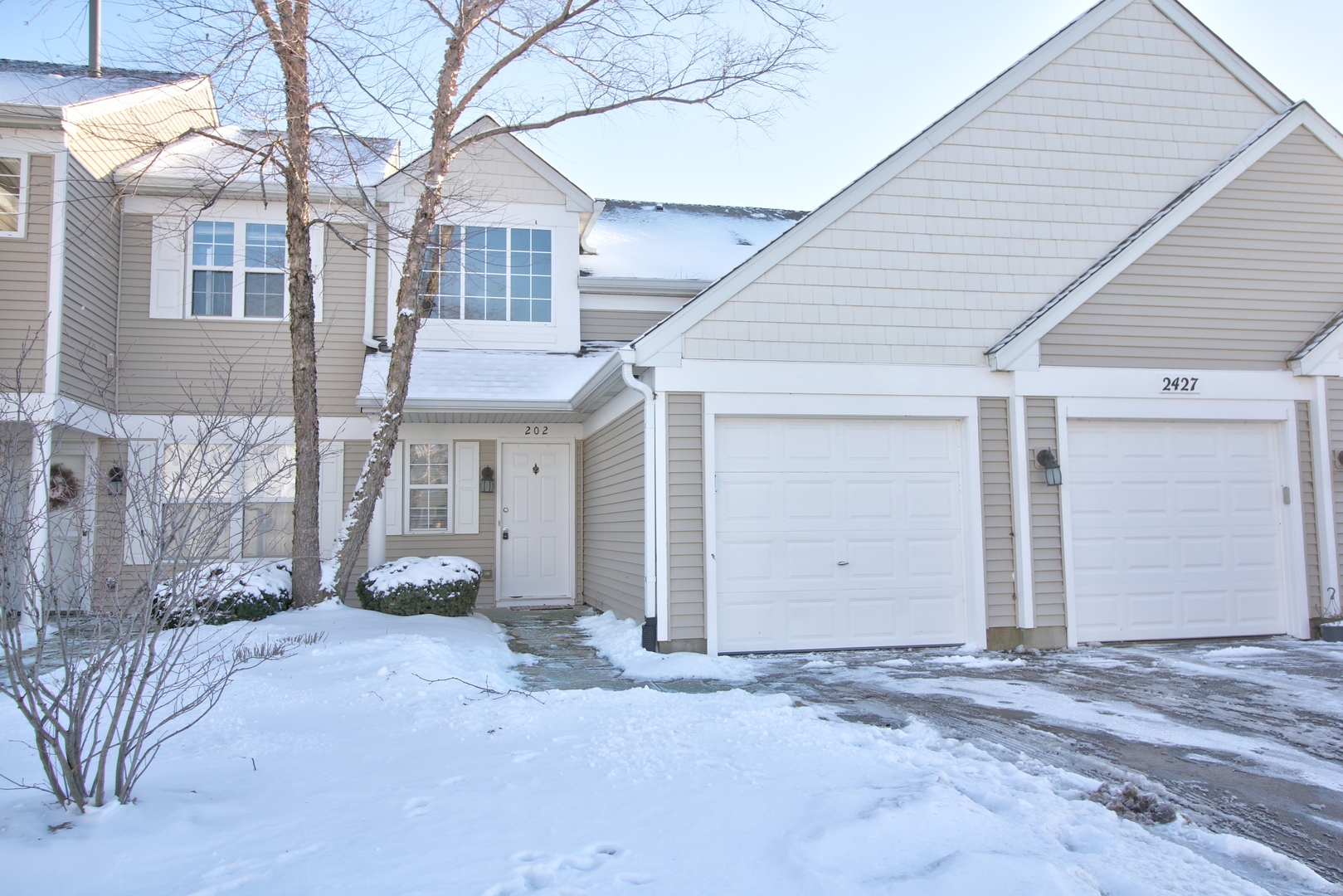 a view of a house with a yard and garage