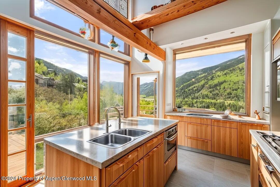 a kitchen with sink a large window and a counter top