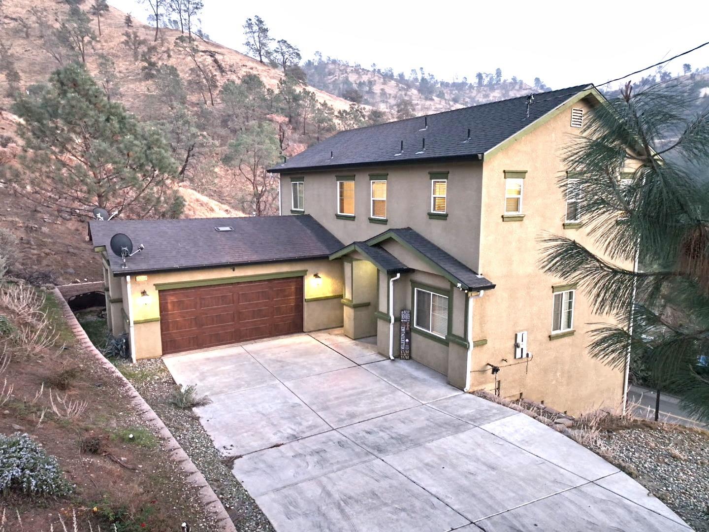 a front view of a house with a yard and garage