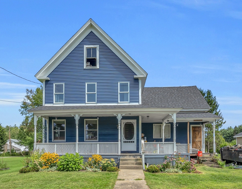 a front view of a house with garden and porch