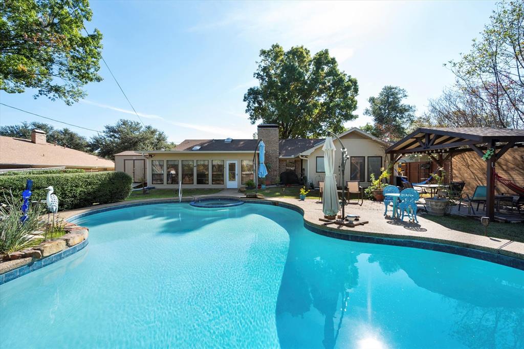 a view of a house with backyard patio and sitting area