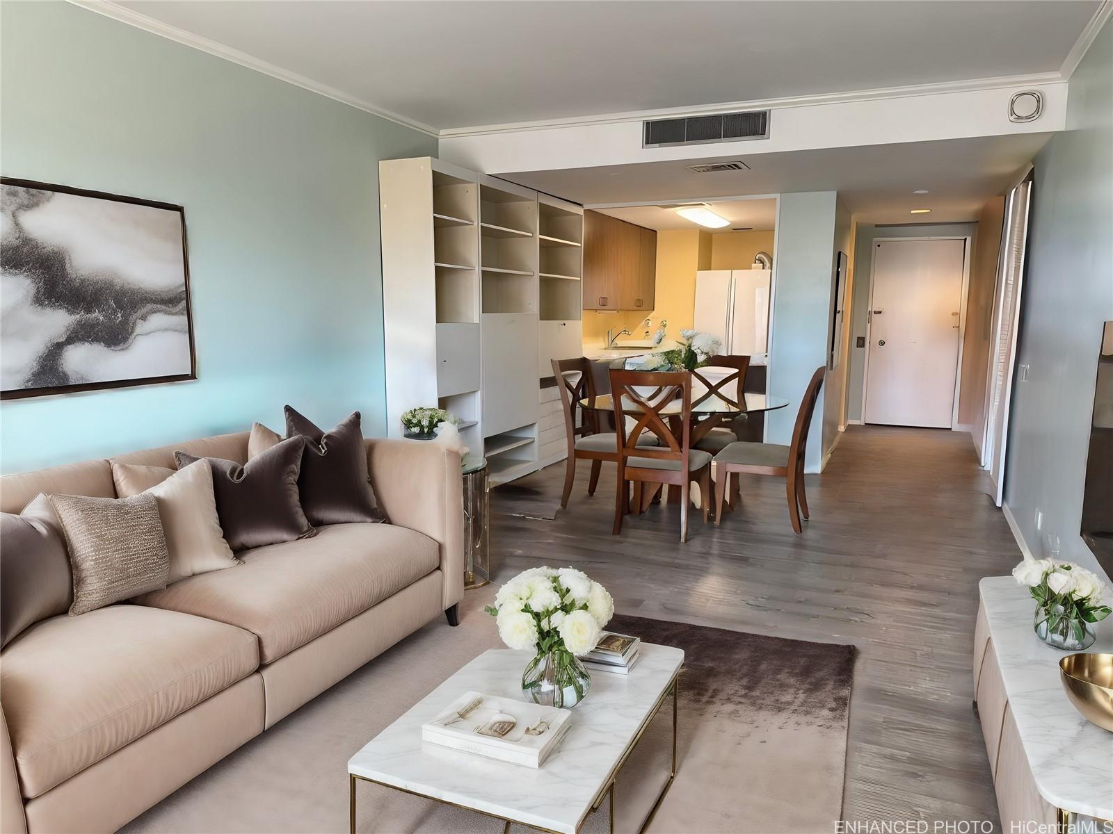 a living room with furniture and wooden floor