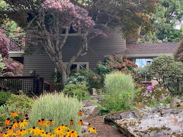 a backyard of a house with lots of green space and lake view