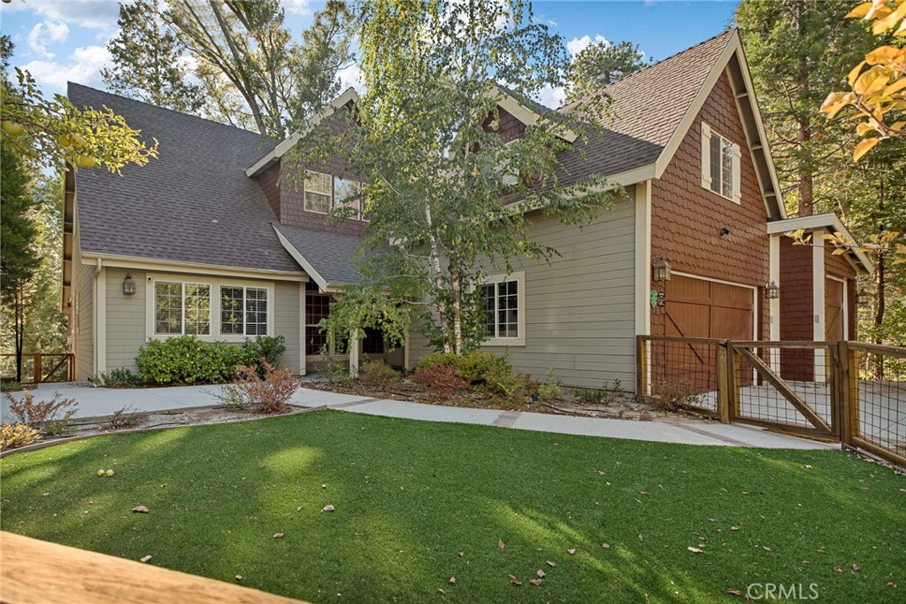 a view of a house with a yard and sitting area