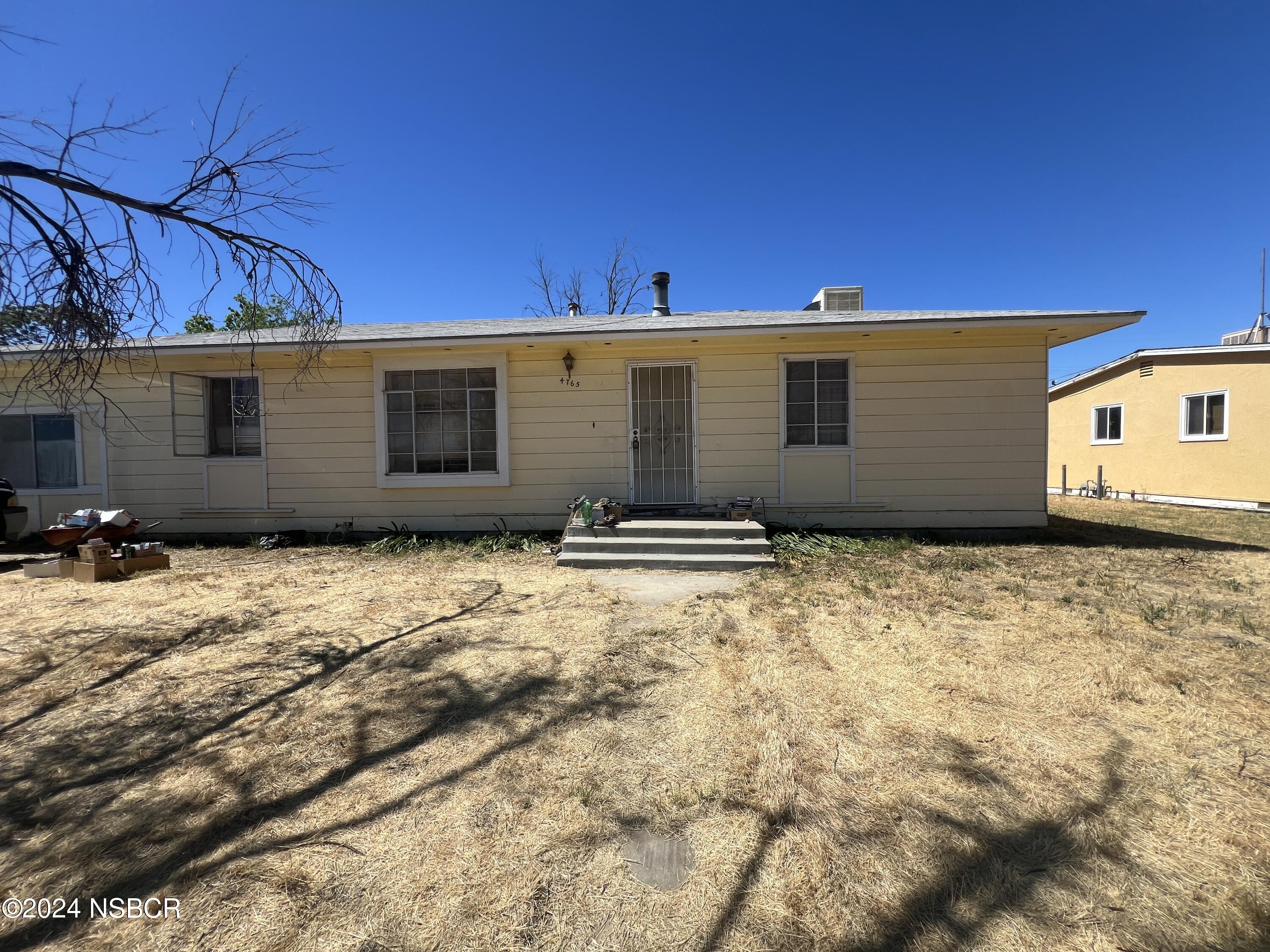 a view of a backyard of the house