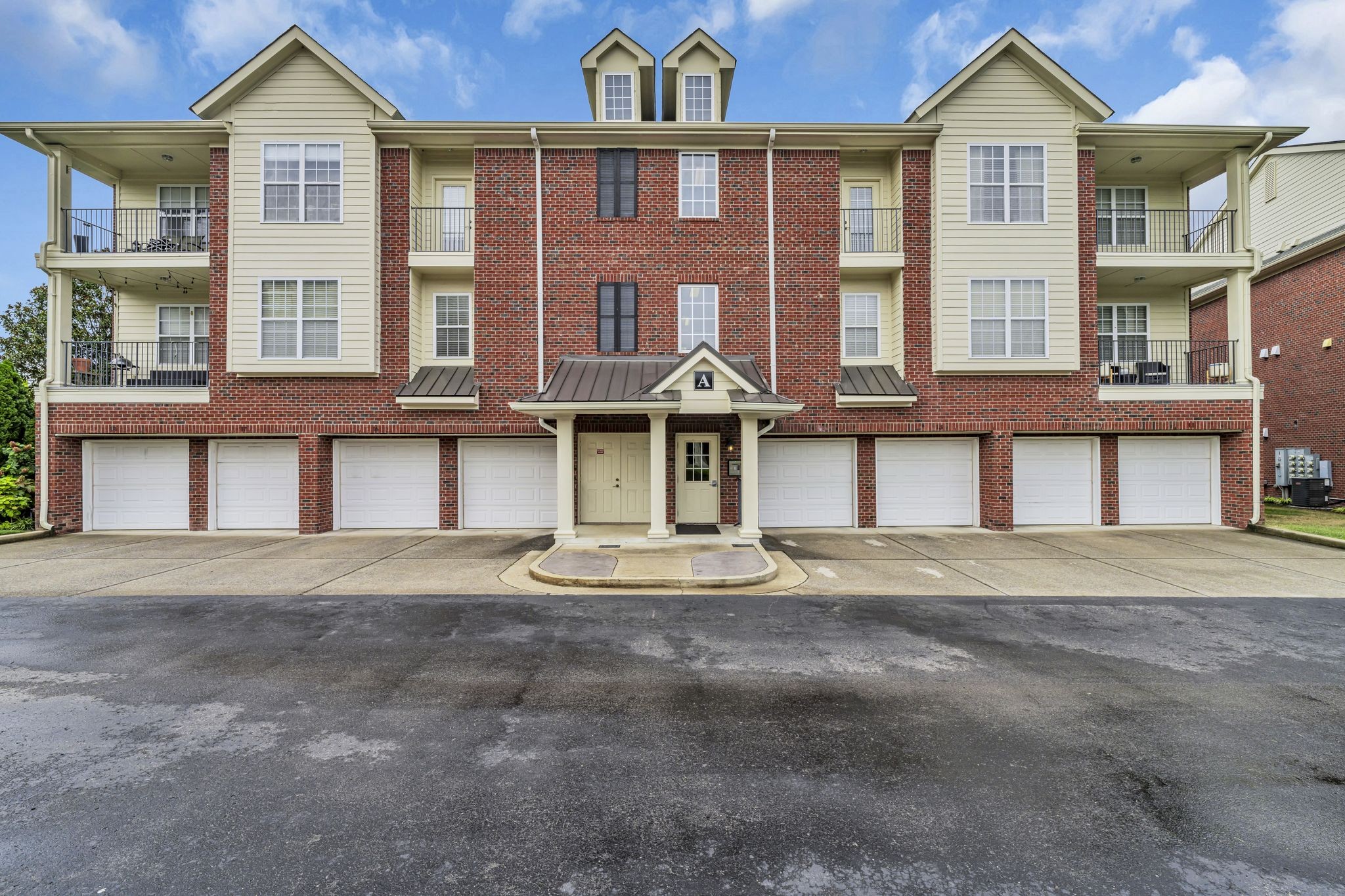 a front view of a residential apartment building with a yard