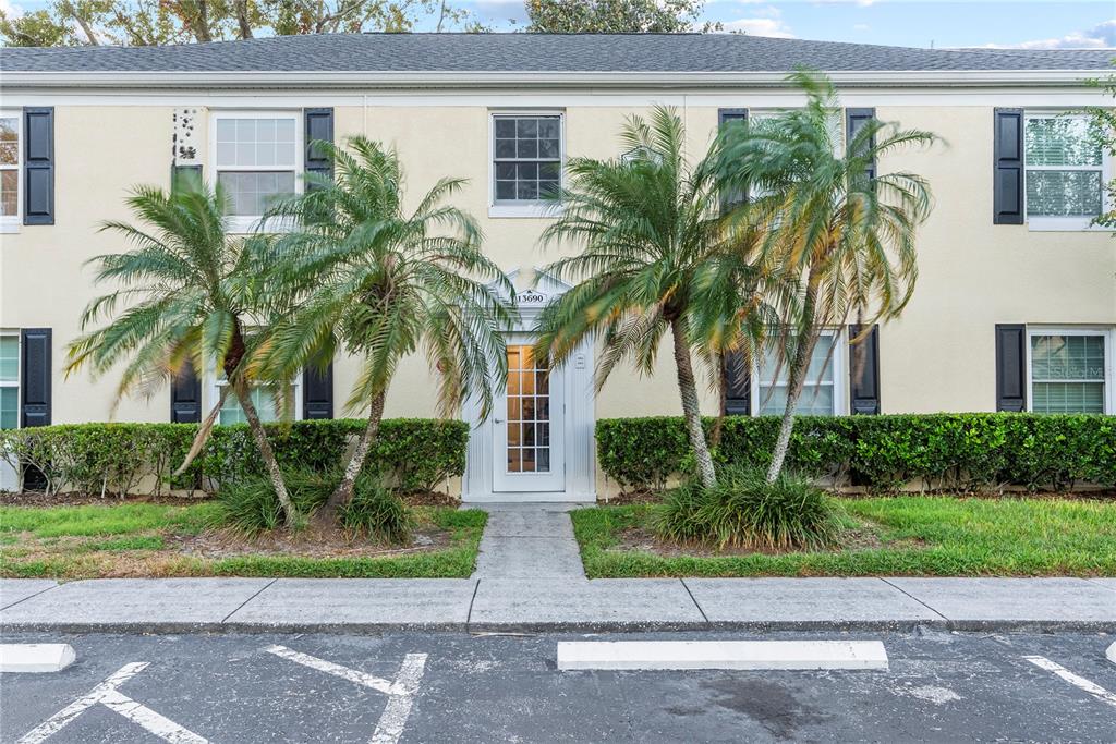 a view of house with palm trees