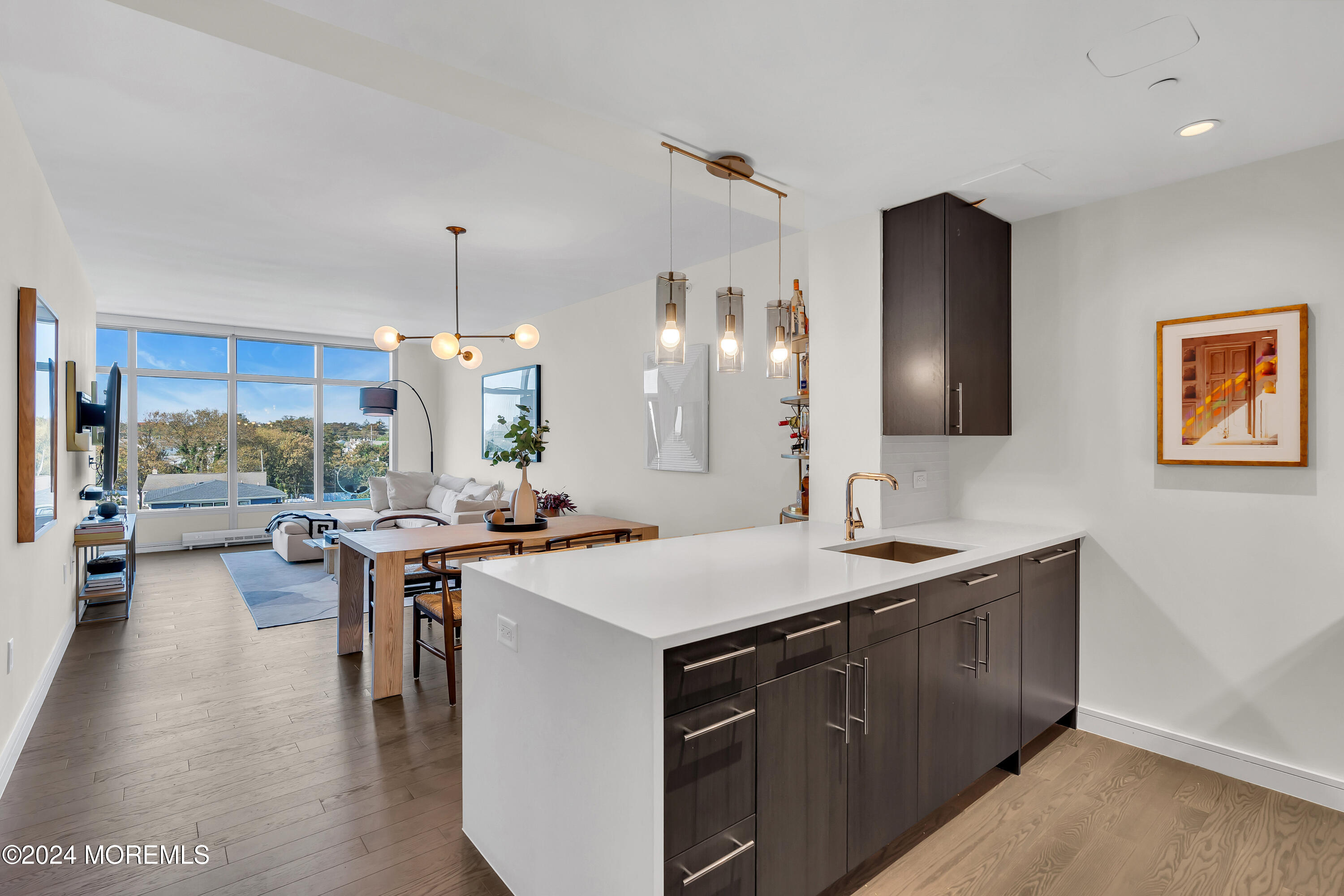 a kitchen with a sink a counter and chairs