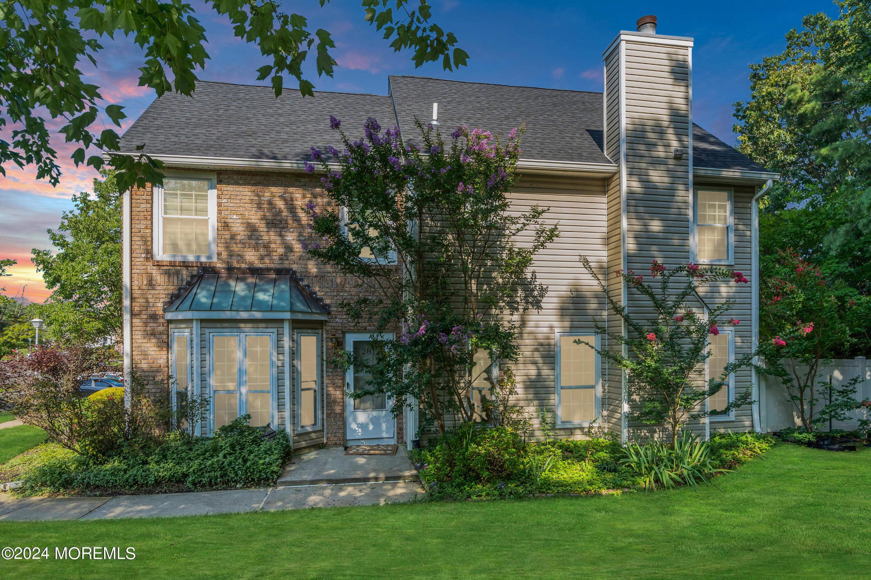 a front view of a house with garden