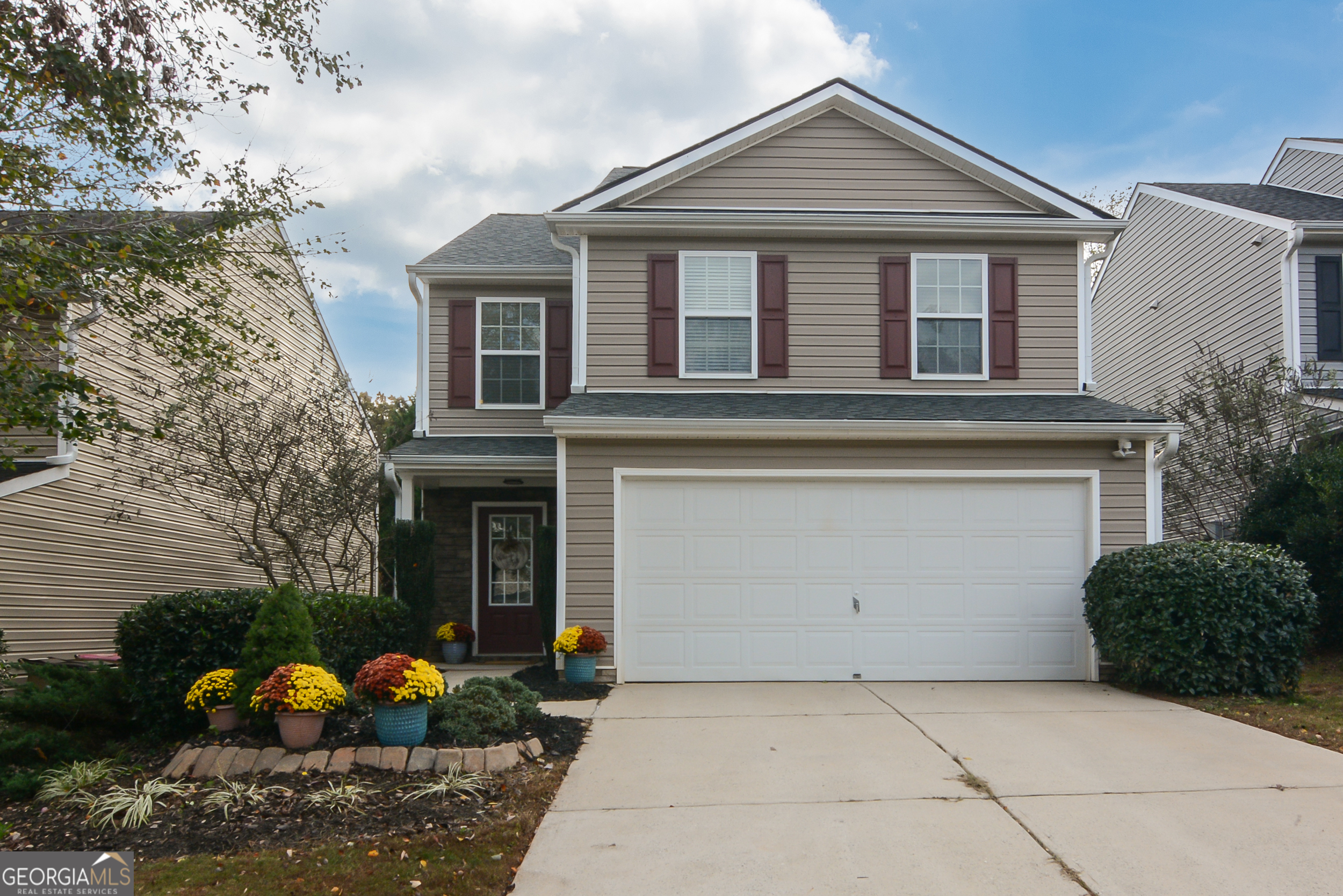 a front view of a house with a yard and garage