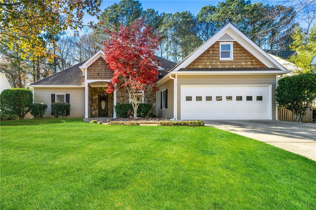 a front view of a house with a yard and garage