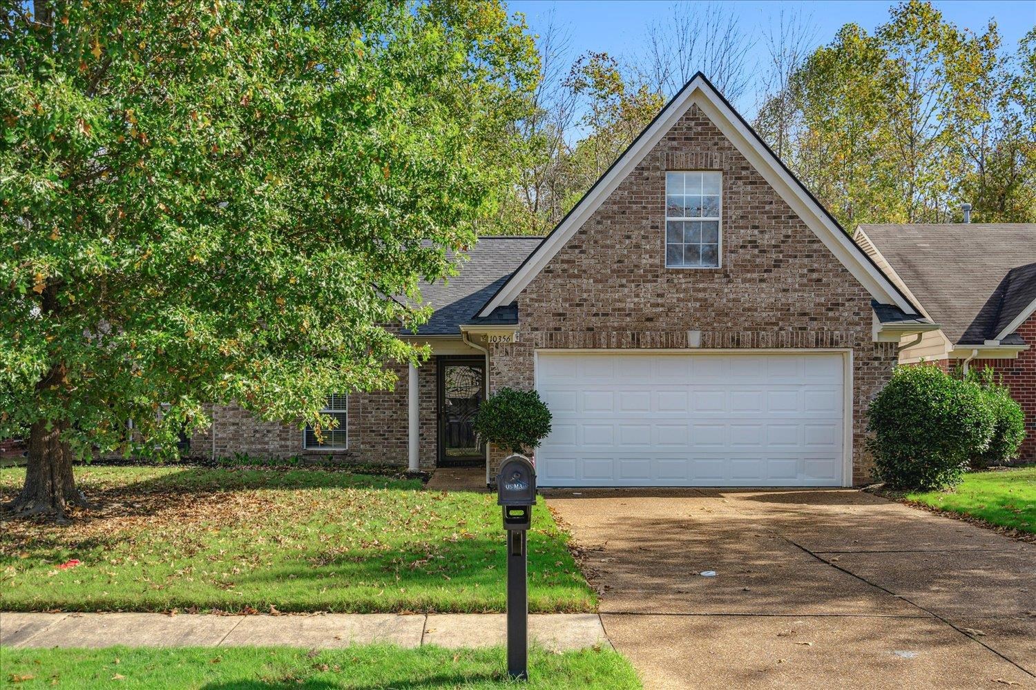 View of front of property featuring a garage and a front yard