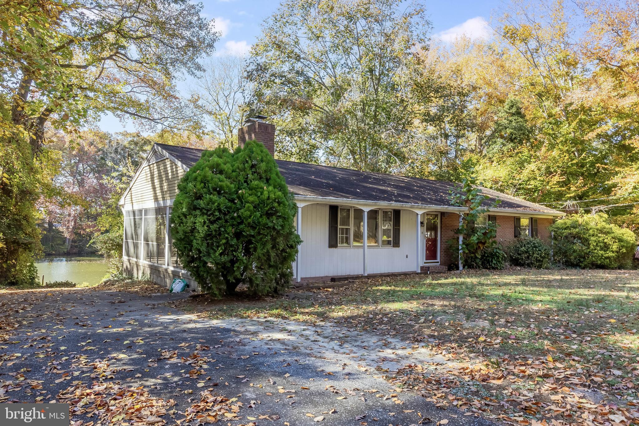 a view of a house with a tree in the yard