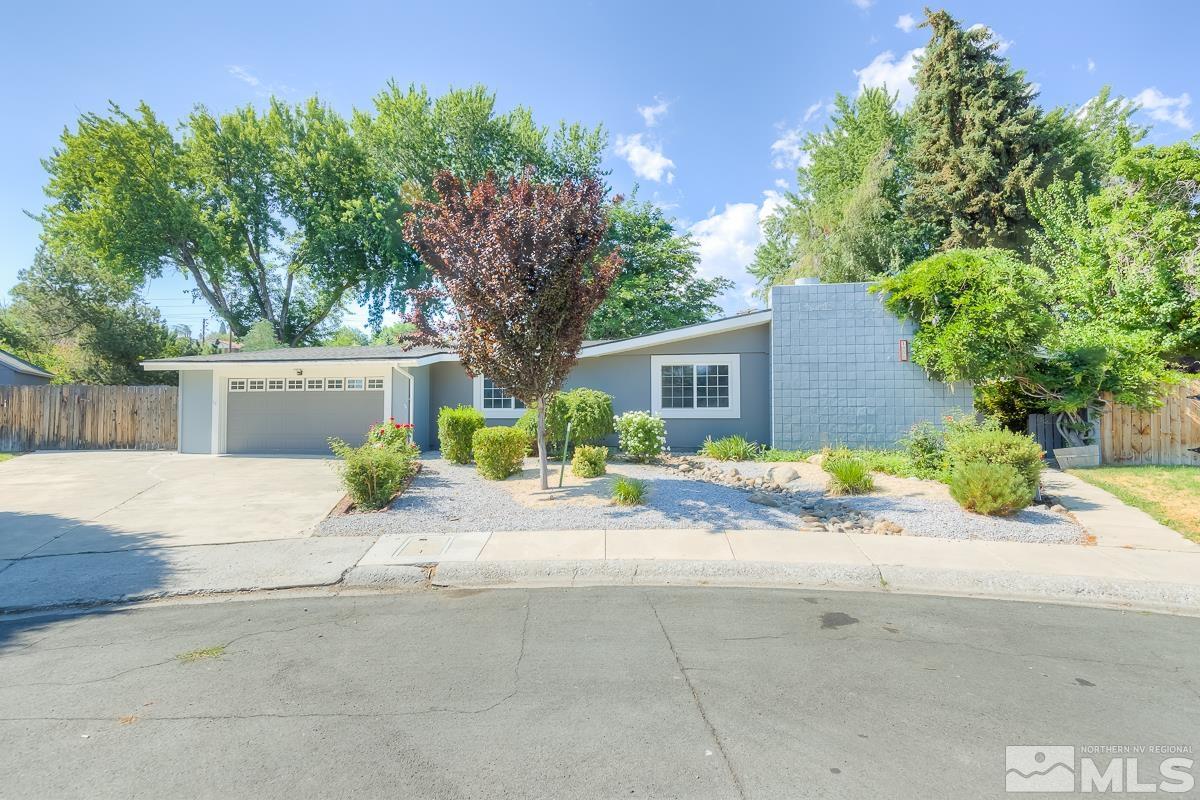 a view of a house with a yard and a garage