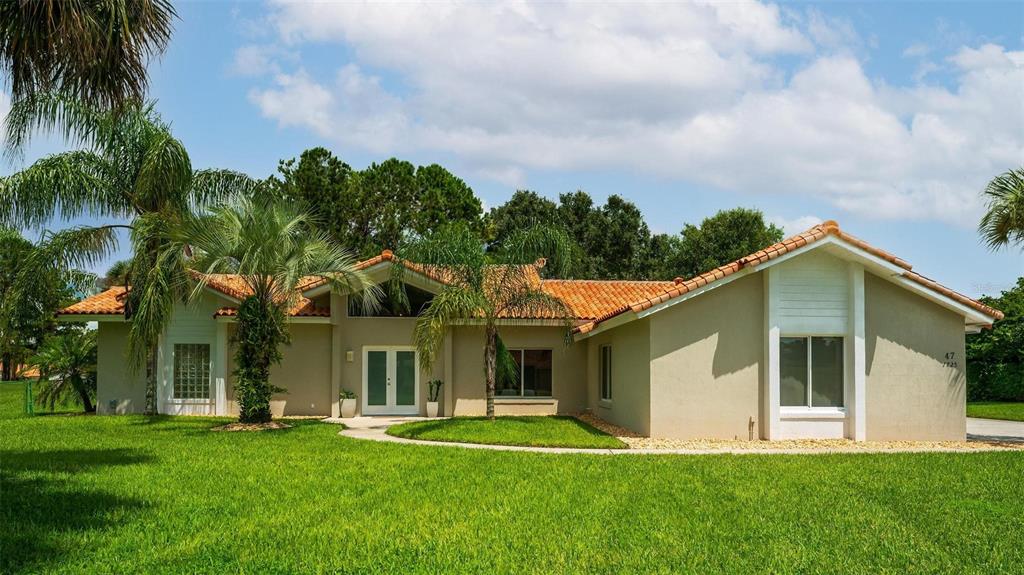 a front view of a house with a garden