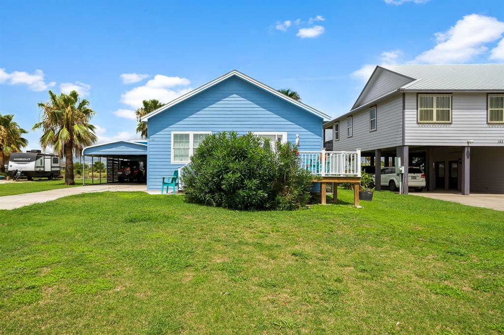 a front view of a house with a yard and trees