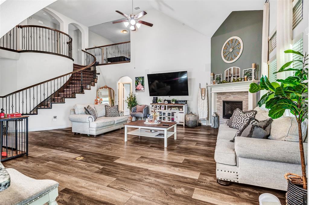 a living room with furniture a fireplace and a flat screen tv