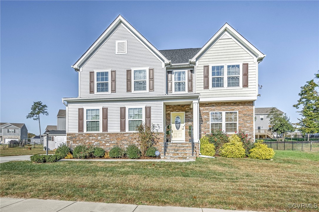 View of front of property with a front yard