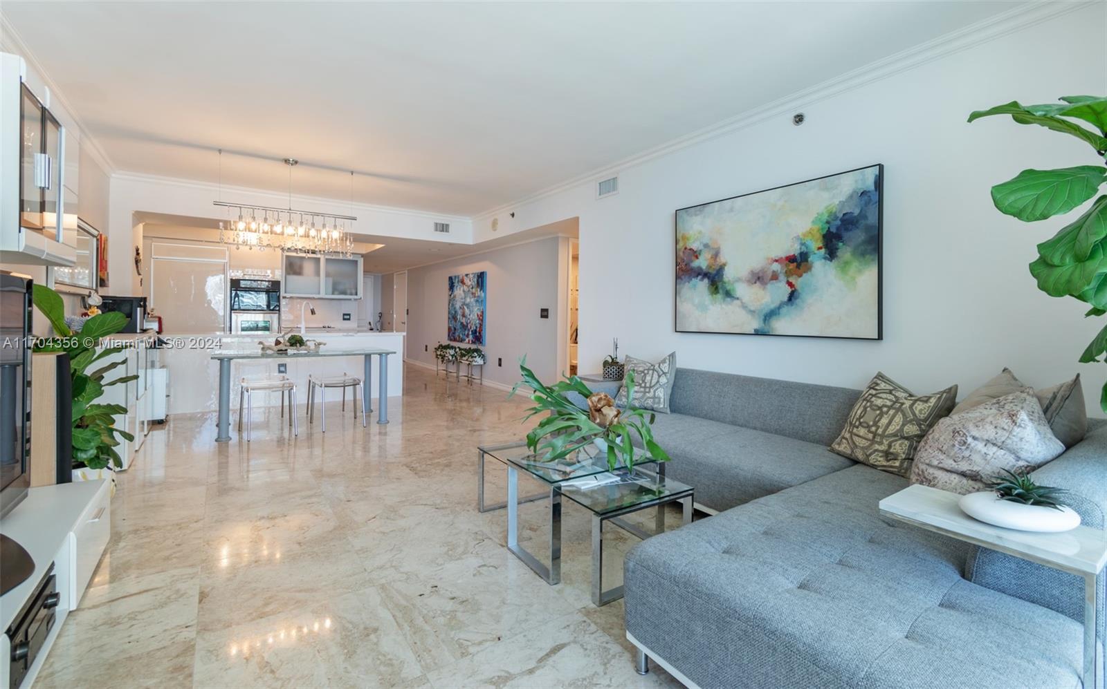 a living room with furniture and dining area