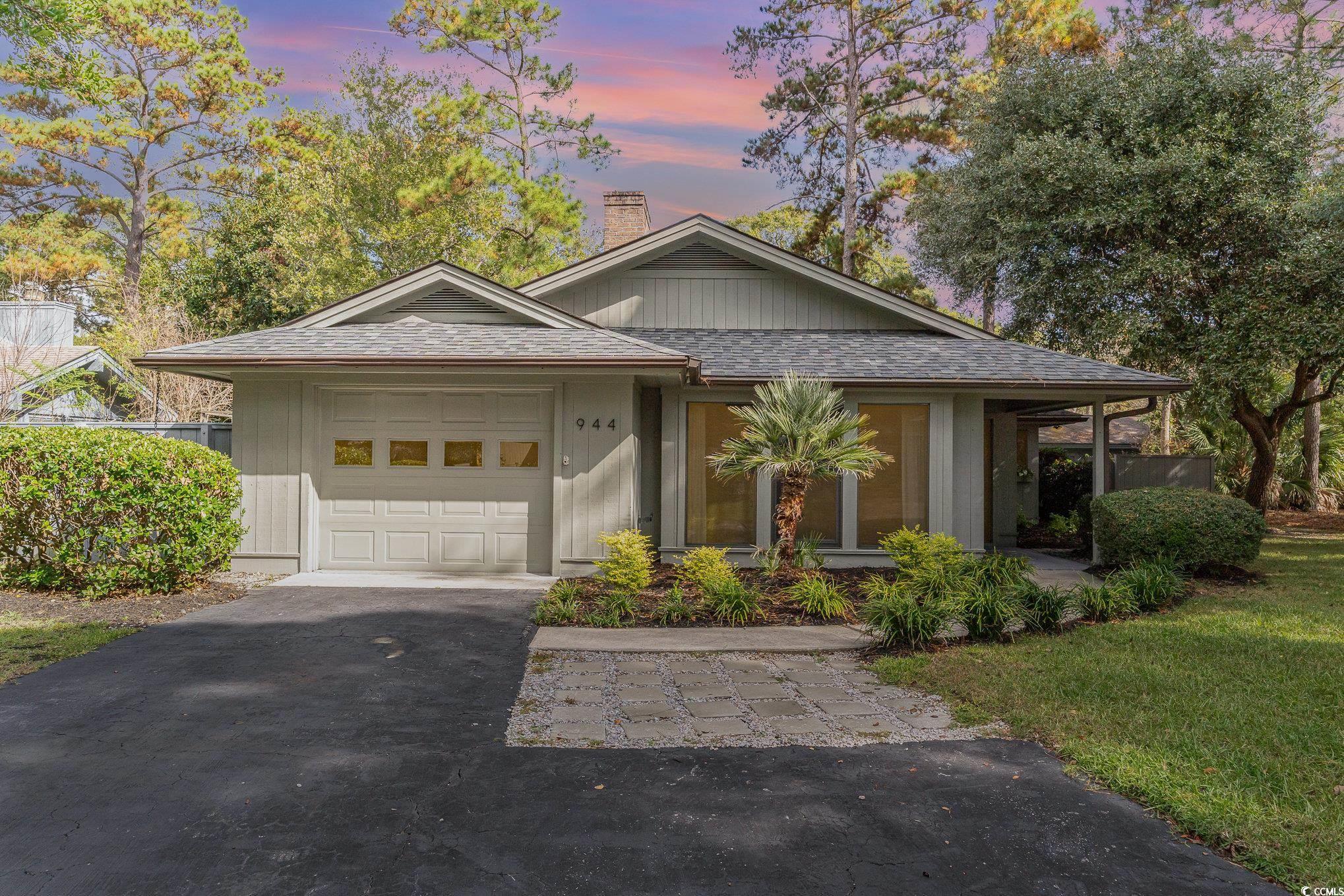 View of front of home with a lawn and a garage