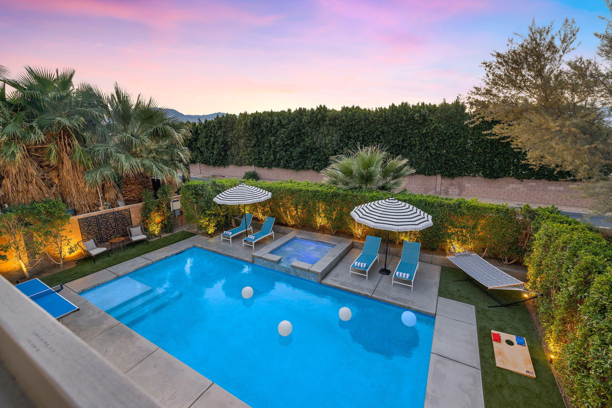 a view of a swimming pool with a patio and a yard