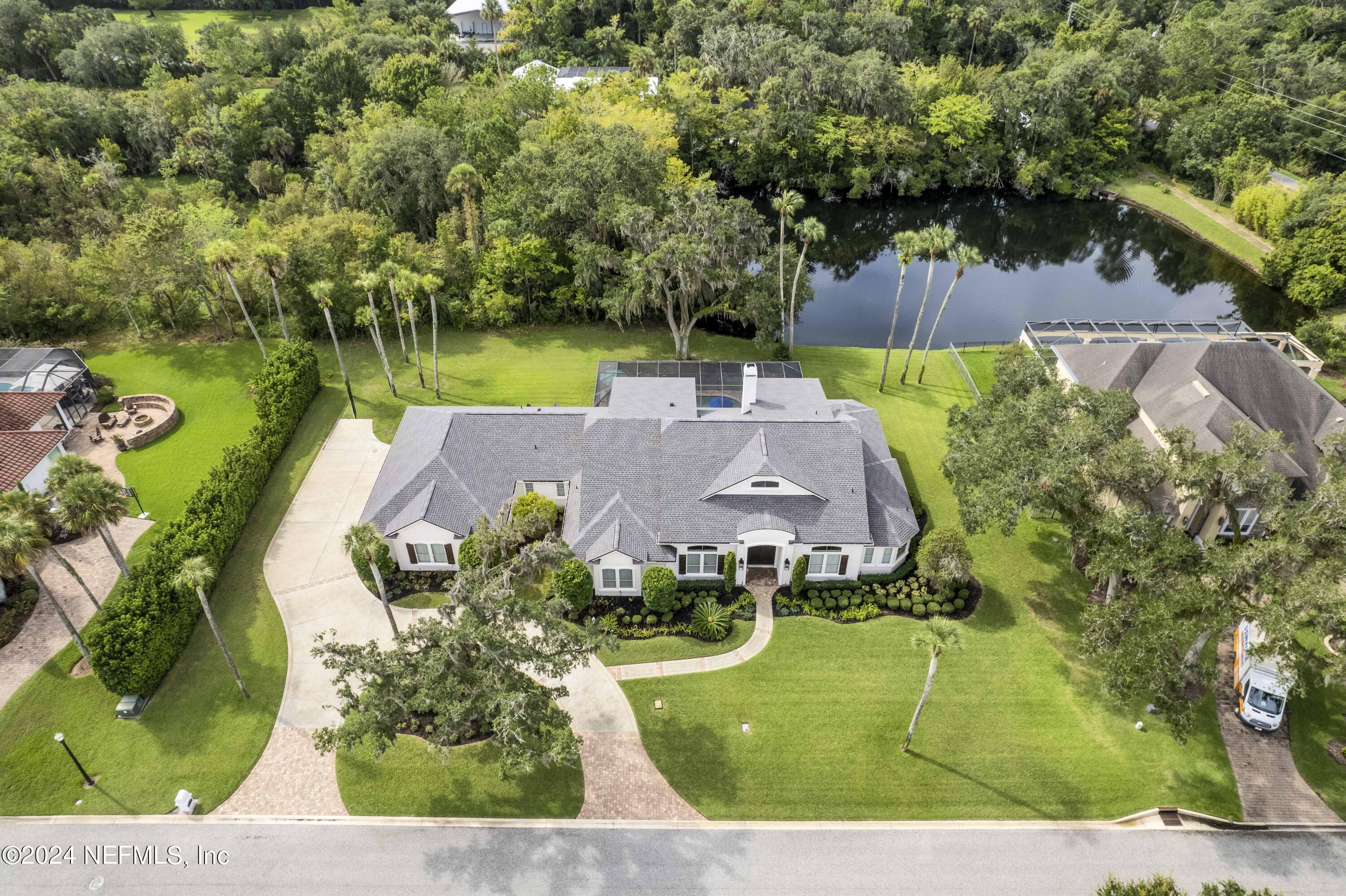 an aerial view of a house with yard swimming pool and outdoor seating