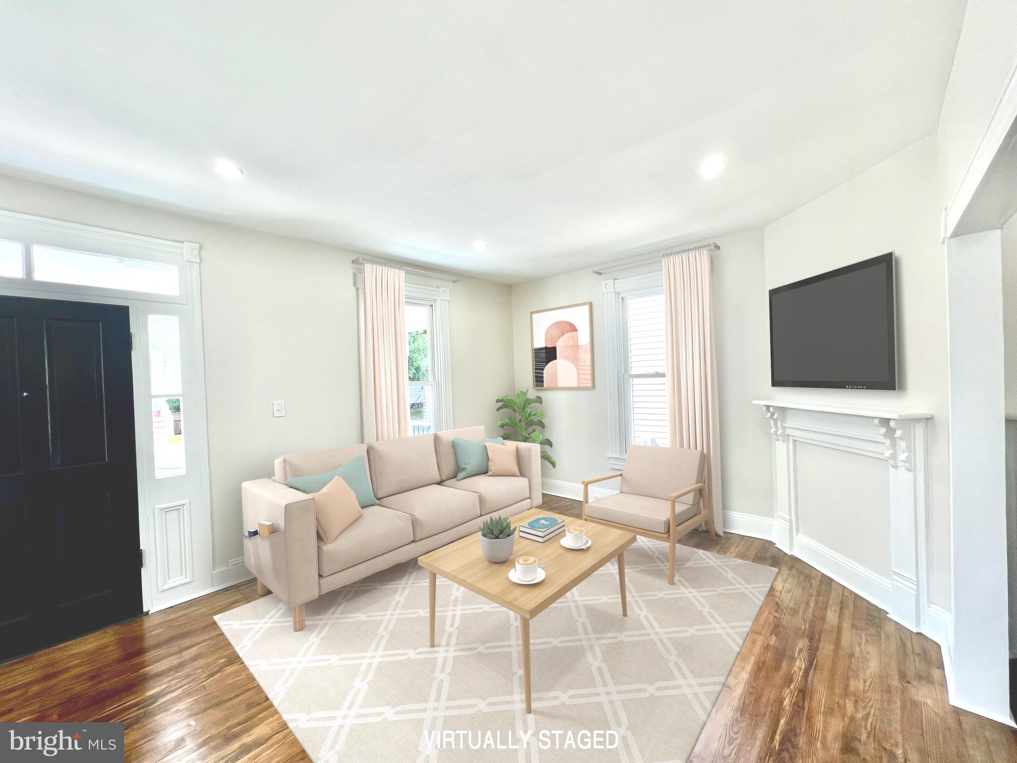 a living room with furniture a flat screen tv and a window