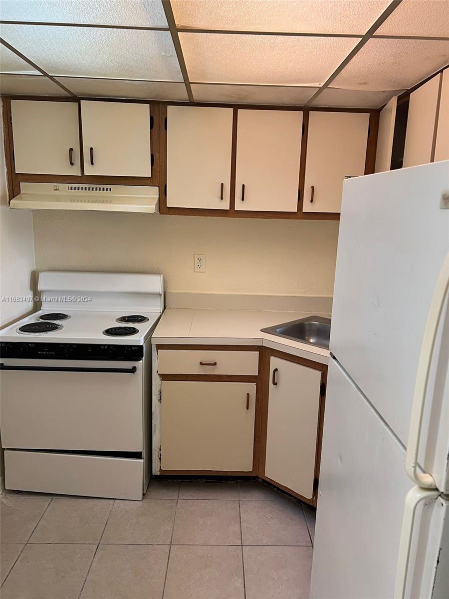 a kitchen with stainless steel appliances granite countertop white cabinets and a stove