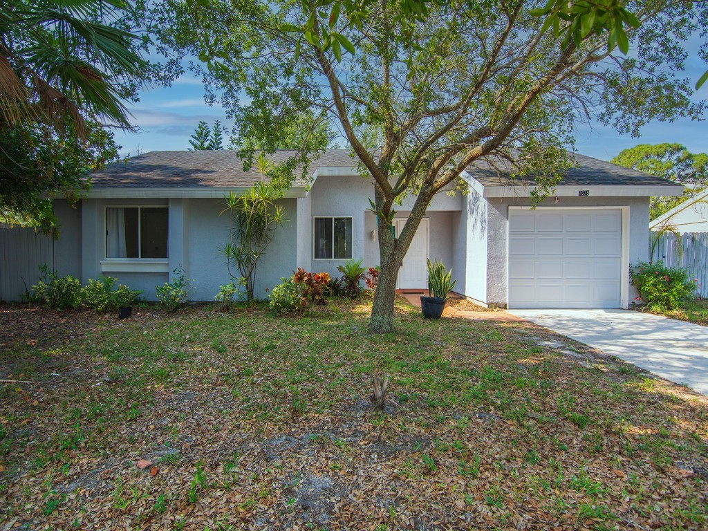 a front view of house with yard and trees