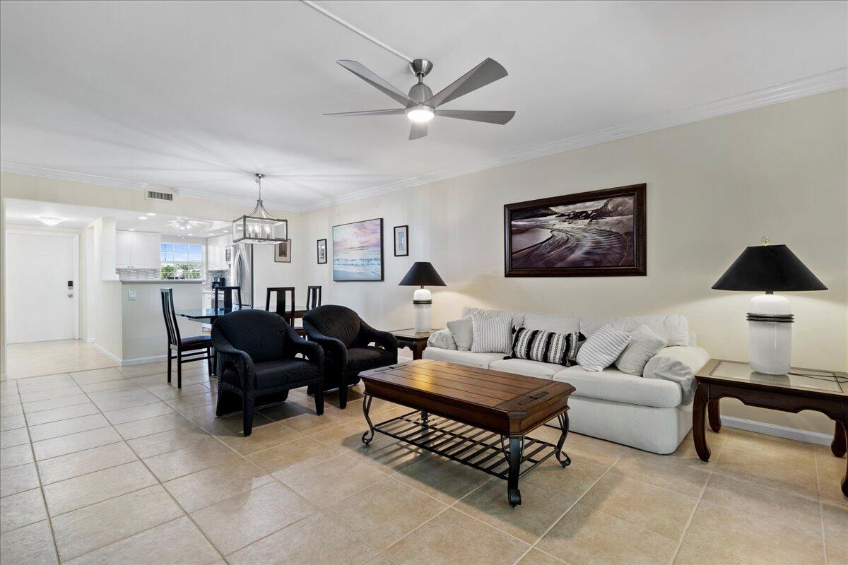 a living room with furniture and a ceiling fan