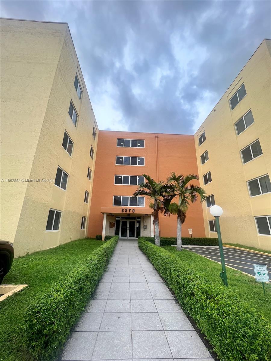 a view of a building with a yard