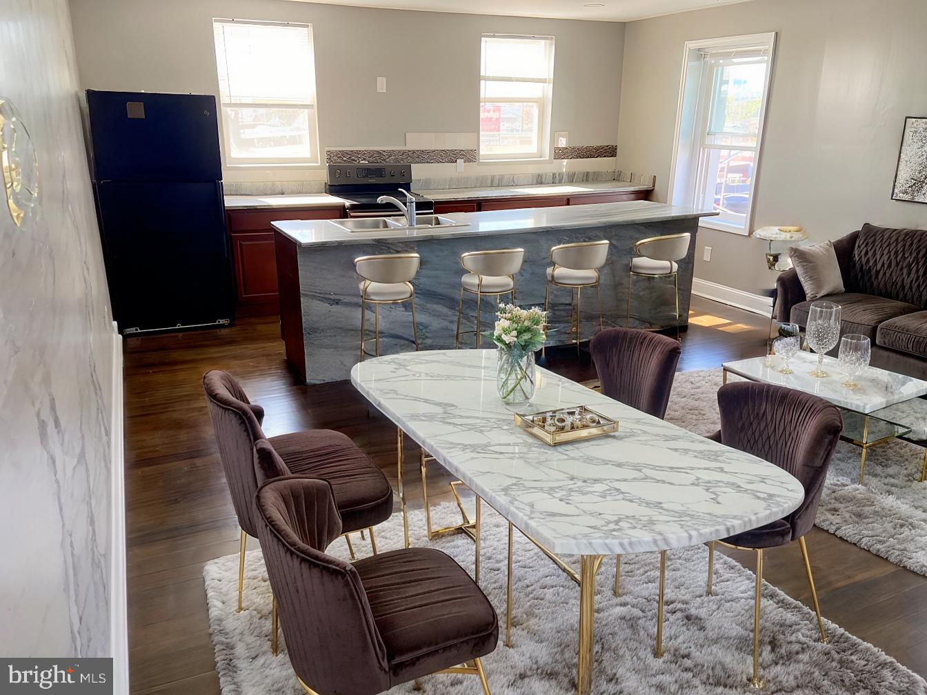 a kitchen with a table chairs and a refrigerator