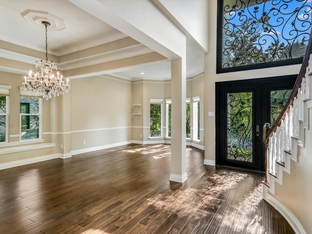 a view of a room with wooden floor and large windows