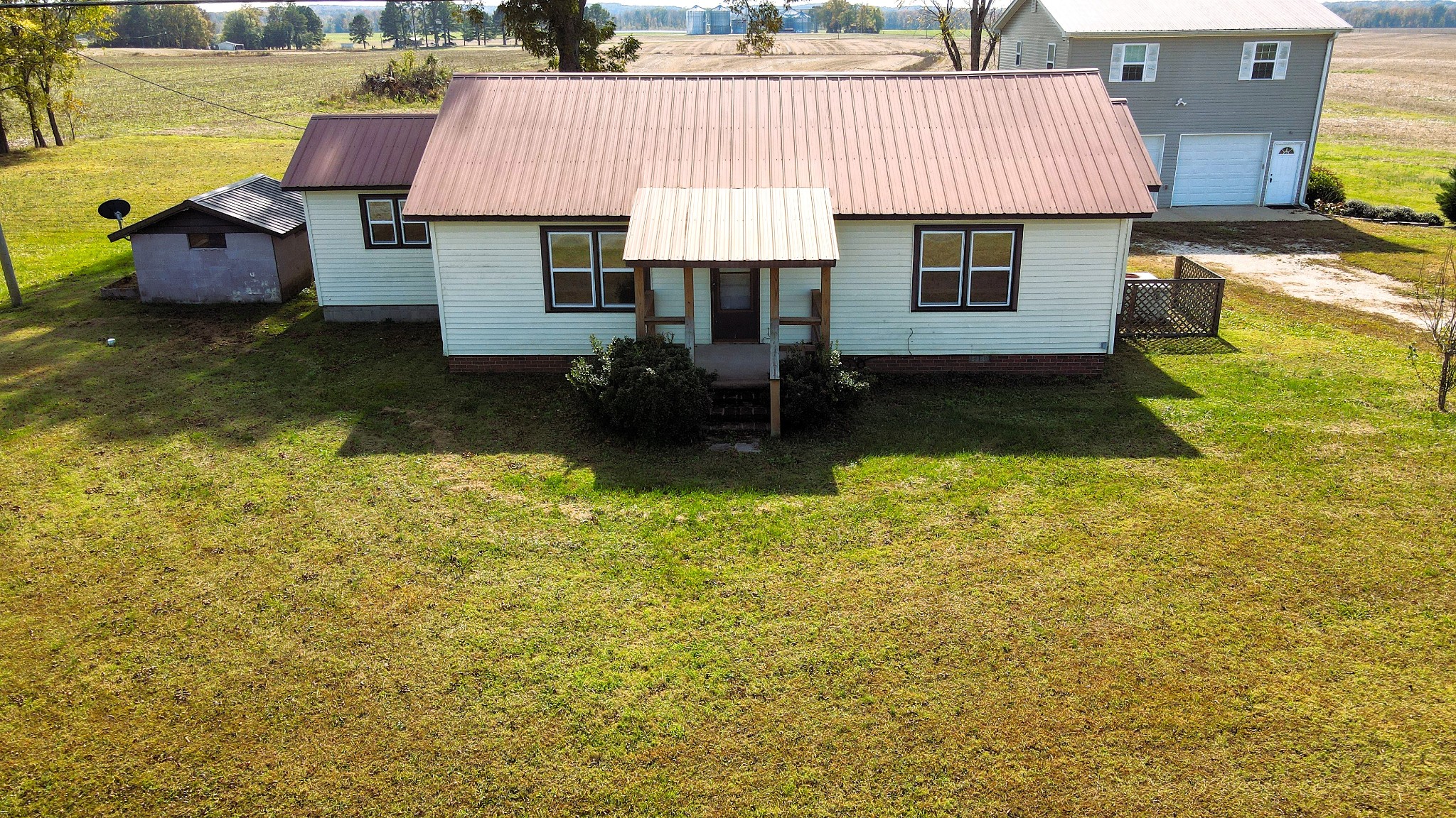 an aerial view of a house with swimming pool patio and yard