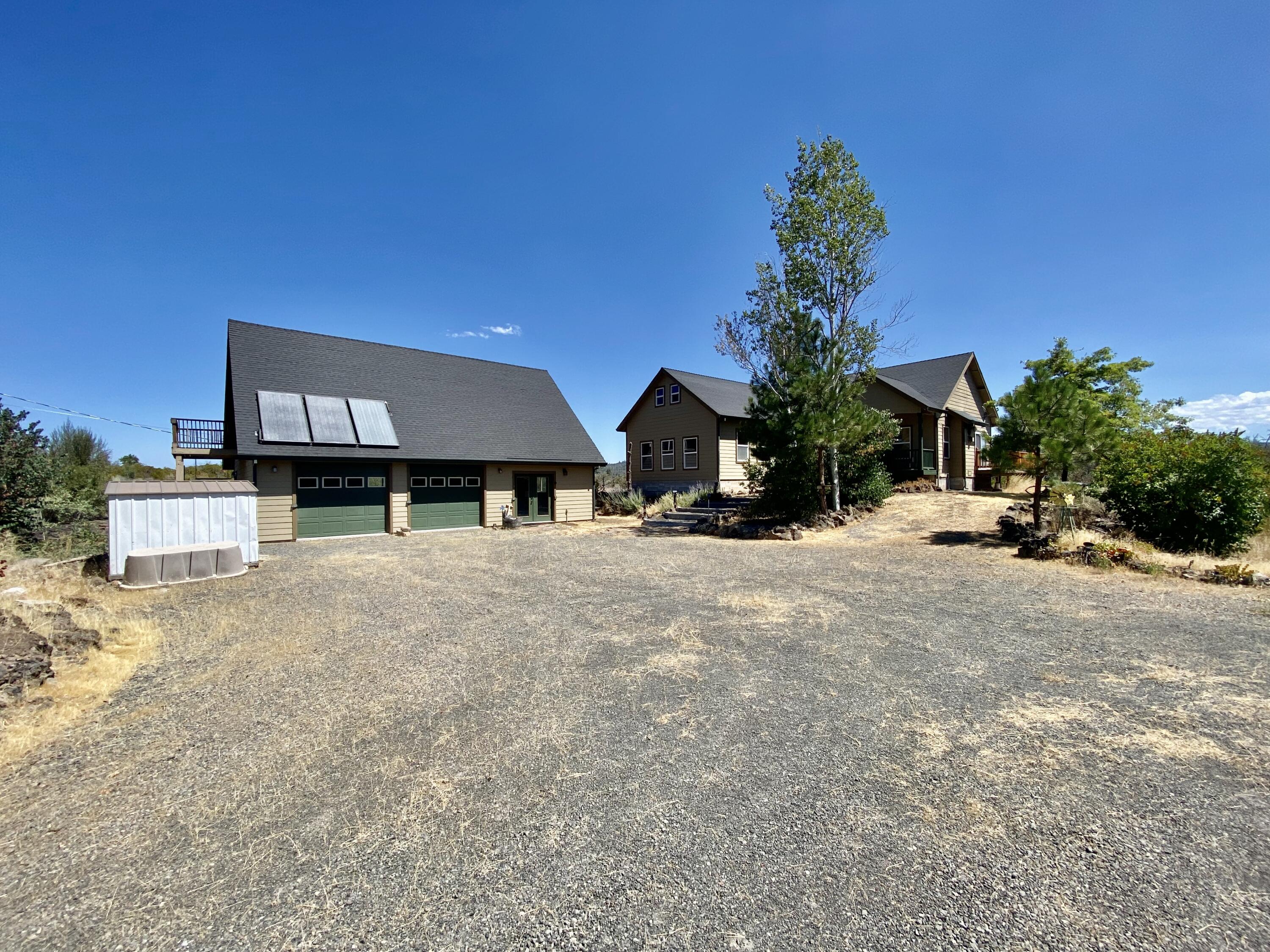 a view of a house with a yard and garage